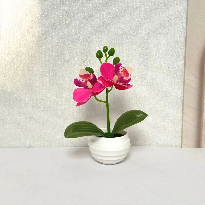 Lebensechte dekorative Orchideenpflanzenarrangement für die Wohnkultur