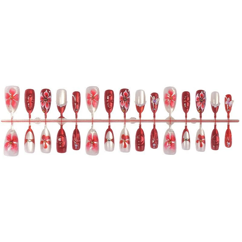 Kunstnagelset mit floralen Designs und Glitzerelementen Karnz